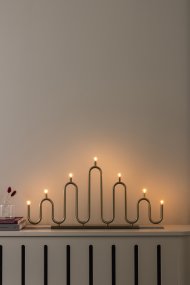 Noel 7 Laiton De Globen Lighting - Son design aux courbes douces, obtenu par le cintrage à la main de tubes métalliques, offre une interprétation moderne du bougeoir classique de l'Avent.