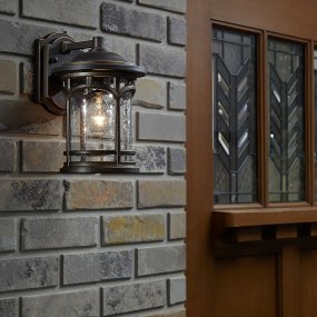 Marblehead Bronze lampe d’extérieur De Elstead Lighting - Le cadre métallique élégant donne au verre clair et texturé une apparence de fenêtre et crée une lumière invitante.