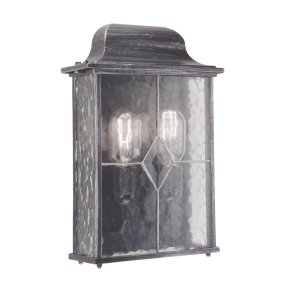 Wexford Argent lampe d’extérieur De Elstead Lighting - Wexford est une applique murale d'extérieur classique en aluminium, avec une élégante finition argent foncé et des panneaux de verre décoratifs à la texture de verre au plomb.