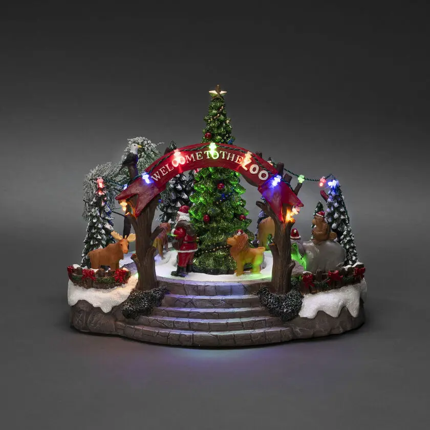 Décoration De Noël Mécanique Avec Zoo 20cm Multicolore De Konstsmide - Cette d&eacute;coration de No&euml;l m&eacute;canique pr&eacute;sente une sc&egrave;ne color&eacute;e avec 19 lumi&egrave;res LED blanches chaudes, de la musique, des animaux et le P&egrave;re No&euml;l autour d'un sapin de No&euml;l &eacute;tincelant.