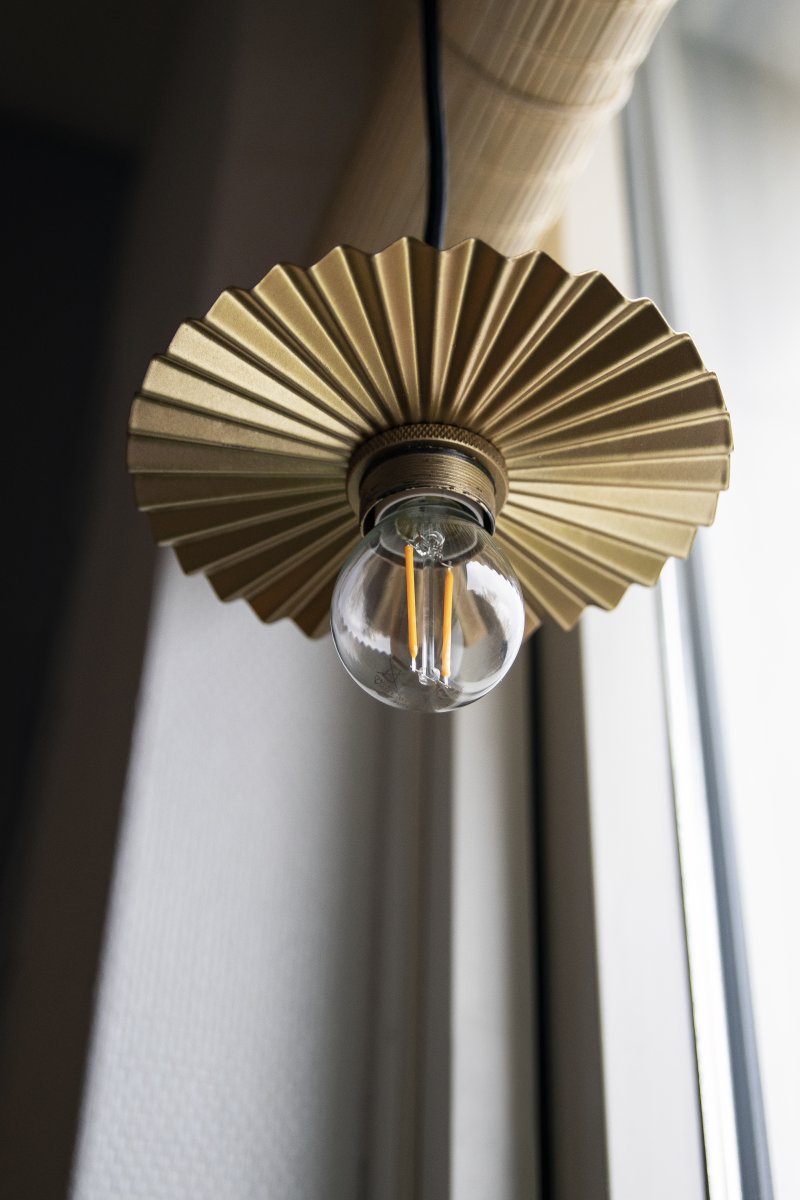 Omega Ø15 Or lampe de fenêtre De Globen Lighting - Le plafonnier Omega, avec son abat-jour en m&eacute;tal pliss&eacute; dor&eacute;, est un luminaire compact et &eacute;l&eacute;gant qui s'int&egrave;gre parfaitement &agrave; une fen&ecirc;tre ou peut &ecirc;tre utilis&eacute; comme suspension dans une cuisine, par exemple.