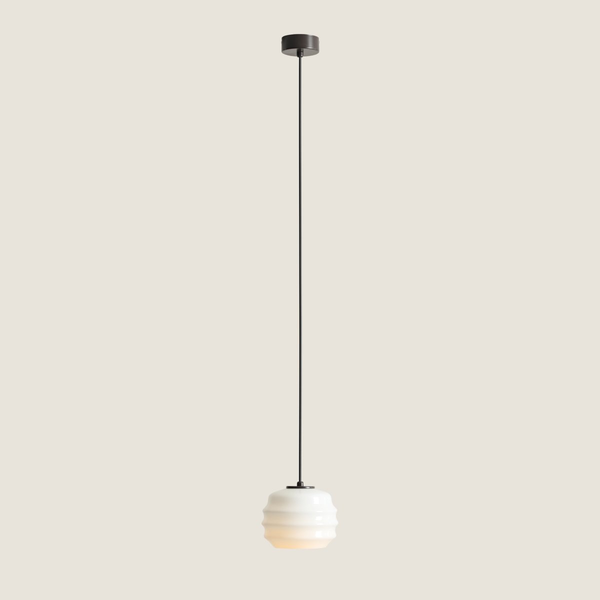 Puff Ø16 brun foncé suspension De Artera - Son abat-jour décoratif en verre opale blanc séduit par sa forme incurvée, conférant à la lampe une allure à la fois ludique et raffinée.