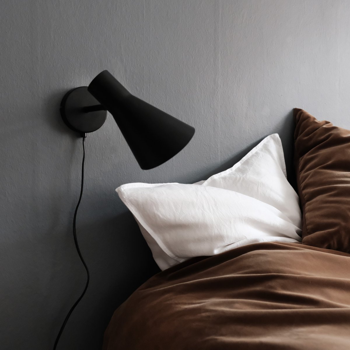 DL12 Noir lampe de lecture De Dyberg Larsen - Avec son design moderne noir mat et son abat-jour incliné, le DL12 fournit une lumière concentrée et agréable, idéale pour les lampes d'angle ou comme lampe de chevet.