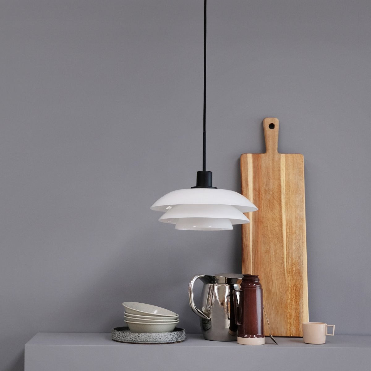 DL31 Ø31 Noir suspension De Dyberg Larsen - La suspension opale DL31 avec une base en métal noir est une lampe élégante qui s'intègre parfaitement au-dessus de la table à manger ou de la table basse.
