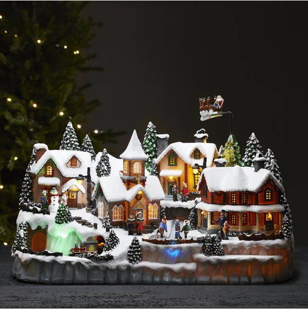 Largeville Multicolore De Star Trading - Grande d&eacute;coration de No&euml;l d&eacute;taill&eacute;e en forme de village, compos&eacute;e de trois &eacute;l&eacute;ments rotatifs&nbsp;: un train, des enfants en patinage, un renne avec son tra&icirc;neau et le P&egrave;re No&euml;l.