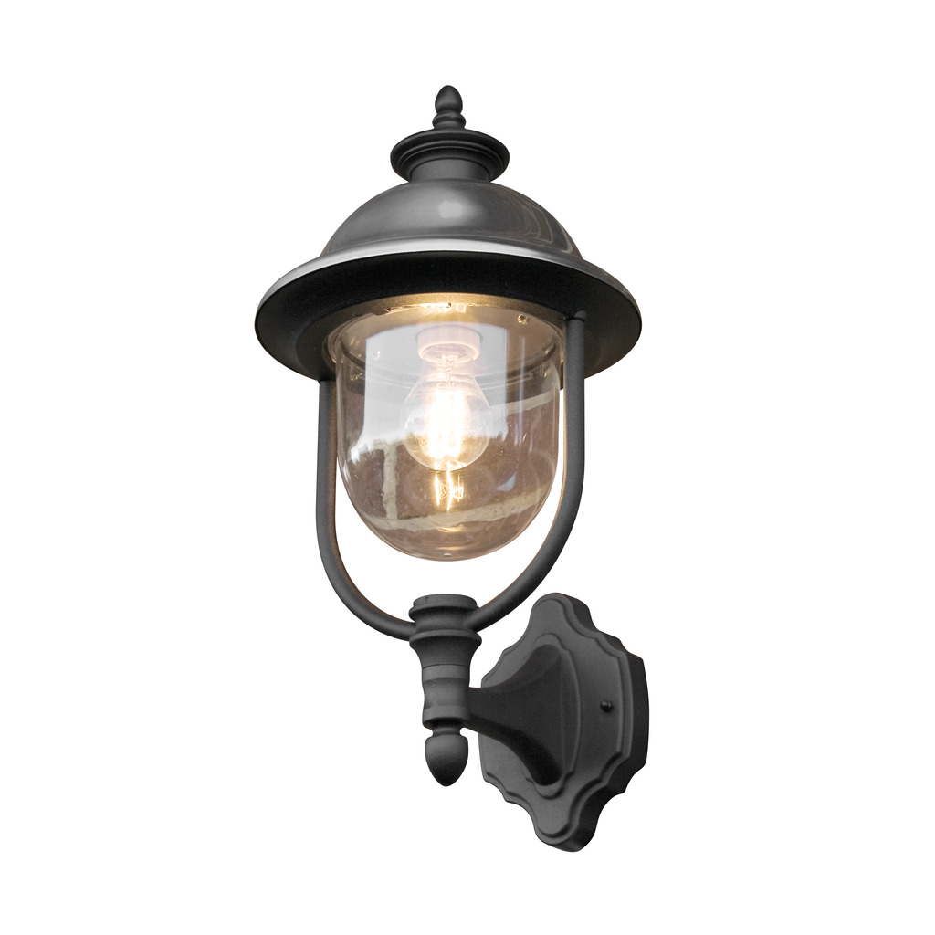 Parma Noir lampe d’extérieur De Konstsmide - Avec sa surface noire robuste et son abat-jour en verre transparent, il émet une lumière chaleureuse et invitante, créant une atmosphère accueillante à l'entrée ou sur la terrasse.