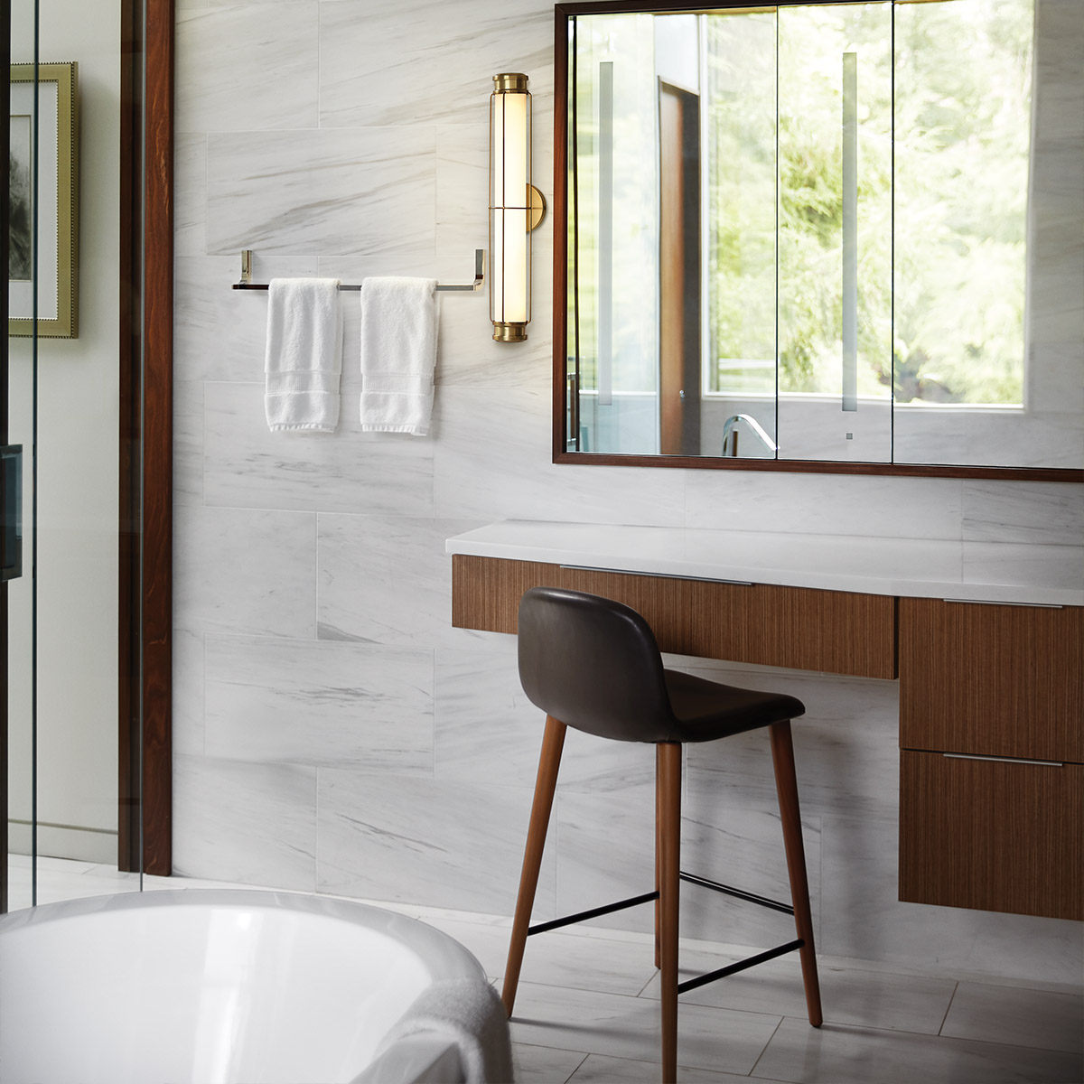 Saylor 60cm Laiton lampe de salle de bain De Elstead Lighting - Fabriqu&eacute;e en m&eacute;tal avec une finition laiton chaleureuse, elle est dot&eacute;e d'un abat-jour allong&eacute; en verre opale qui diffuse une lumi&egrave;re douce et homog&egrave;ne.