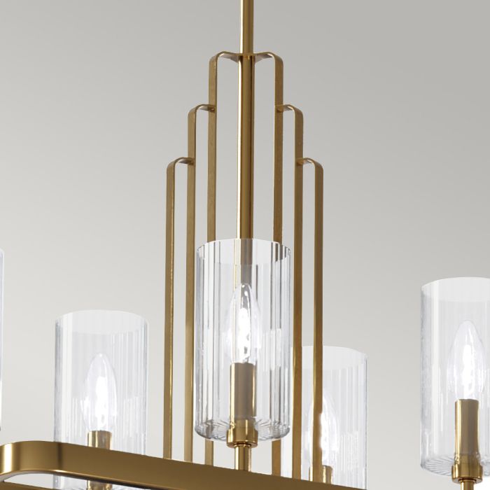 Kimrose 114cm Laiton brossé suspension De Elstead Lighting - Les abat-jour cylindriques en verre sont transparents et présentent des rainures verticales, créant un effet d'éclairage unique et subtil.