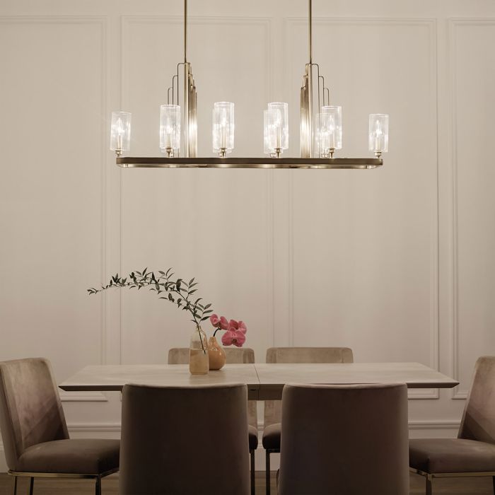 Kimrose 114cm Laiton brossé suspension De Elstead Lighting - Les abat-jour cylindriques en verre sont transparents et présentent des rainures verticales, créant un effet d'éclairage unique et subtil.