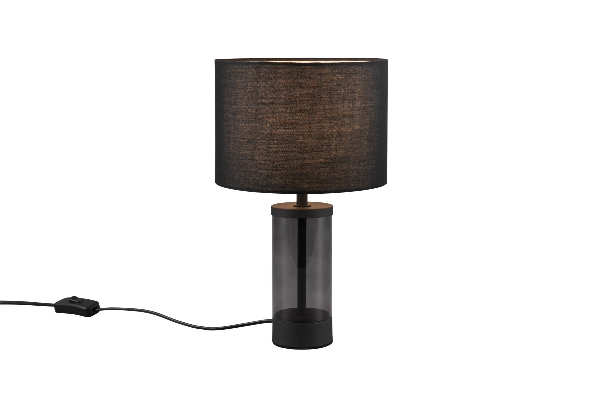 Grazia 34cm Noir lampe de table De Trio Lighting - La lampe de table Grazia combine un élégant abat-jour en tissu avec une base cylindrique élégante en verre et en métal, créant une impression harmonieuse et élégante.